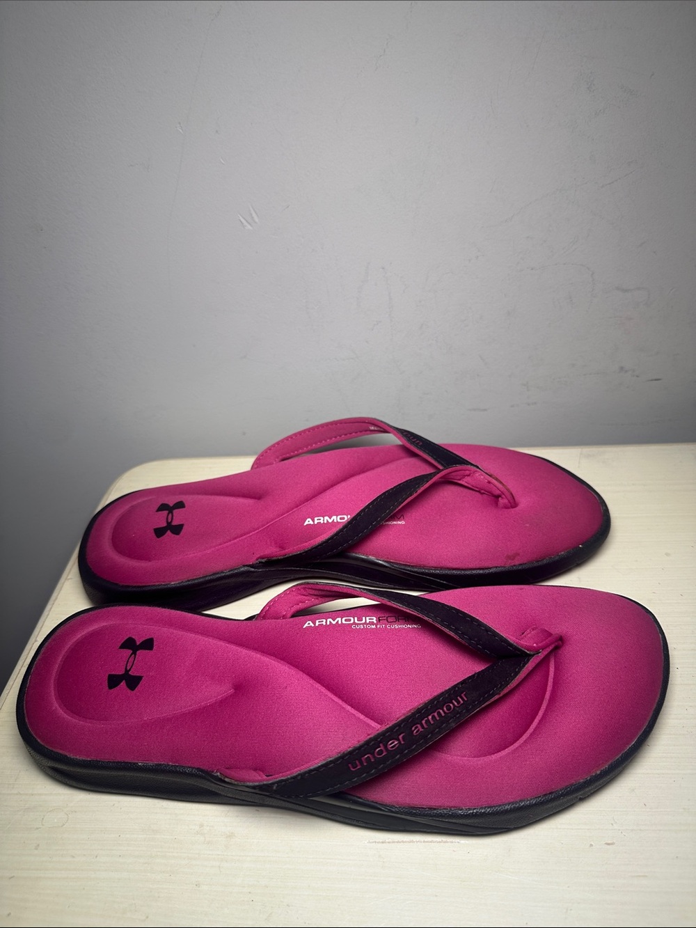 Under Armour Women’s Hot Pink form Flip Flop Sandals with Black Trim